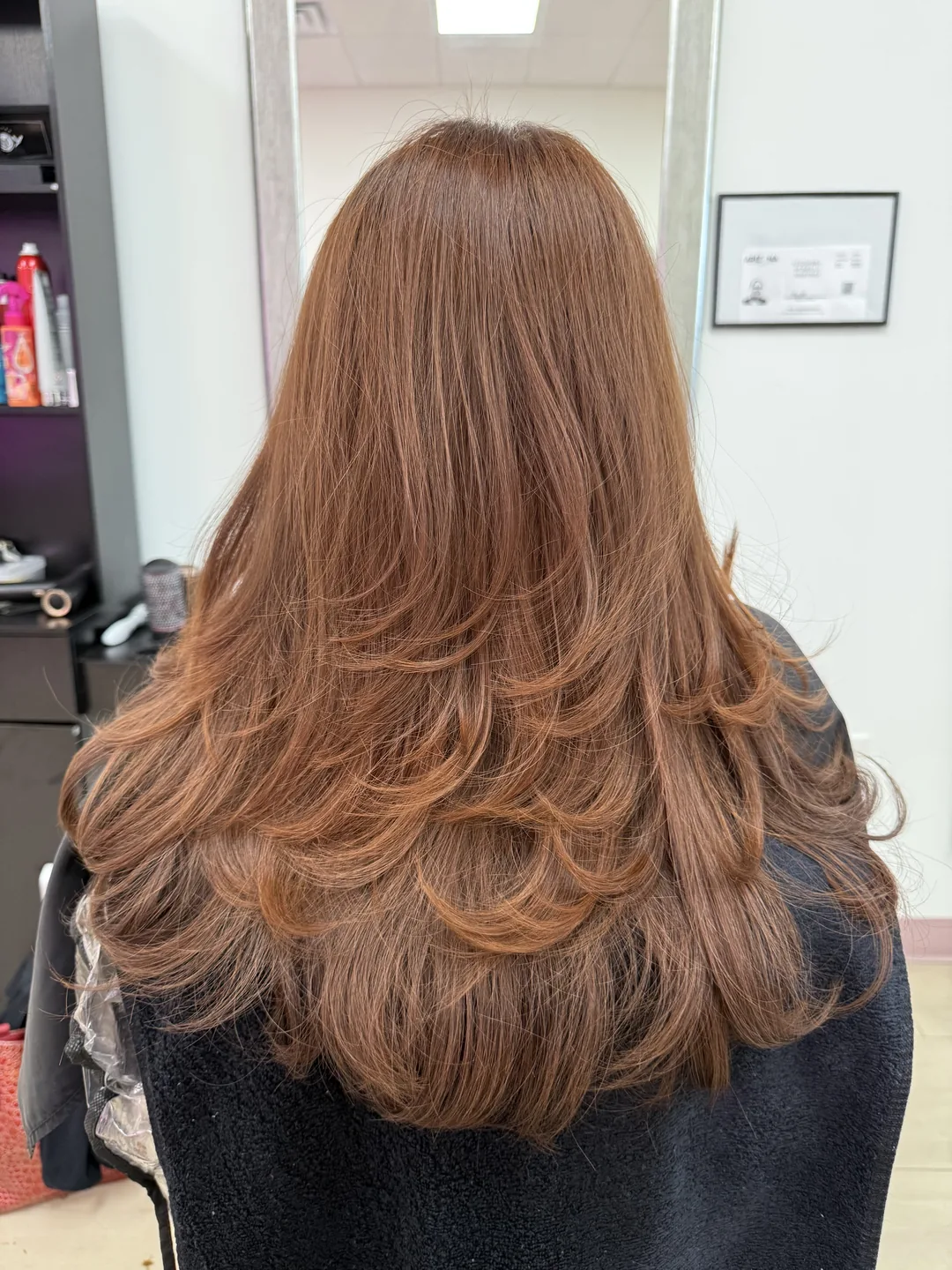 medium copper blonde with soft layered curls, back view