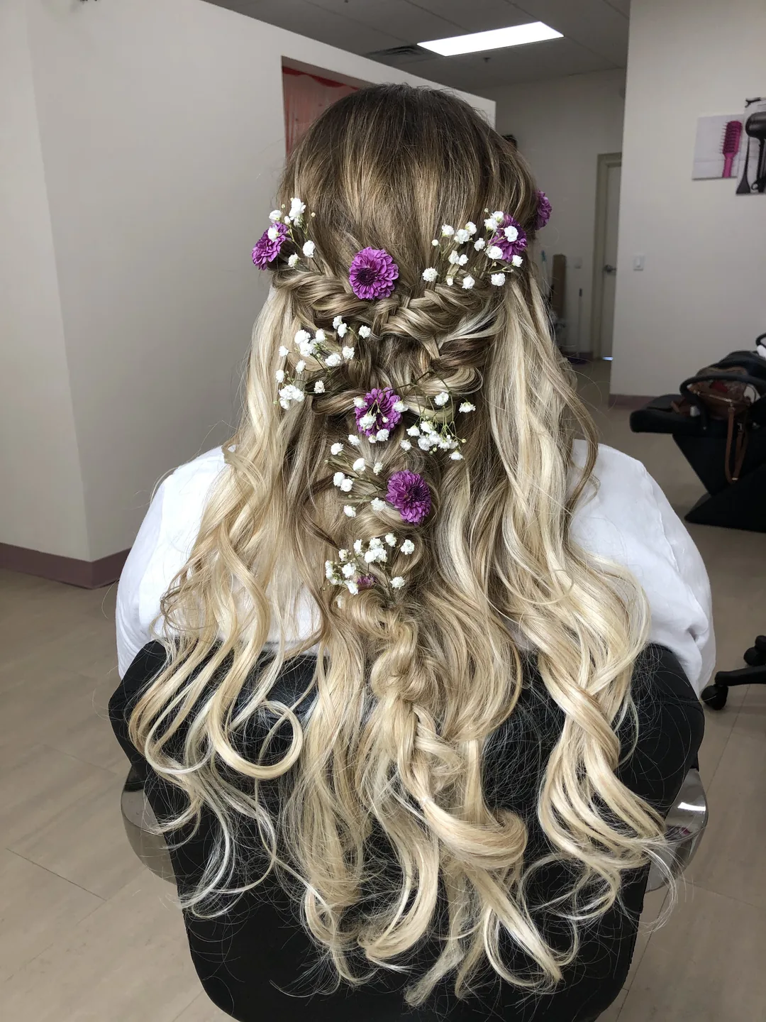 bridal half-up braid with purple and baby's breath flowers