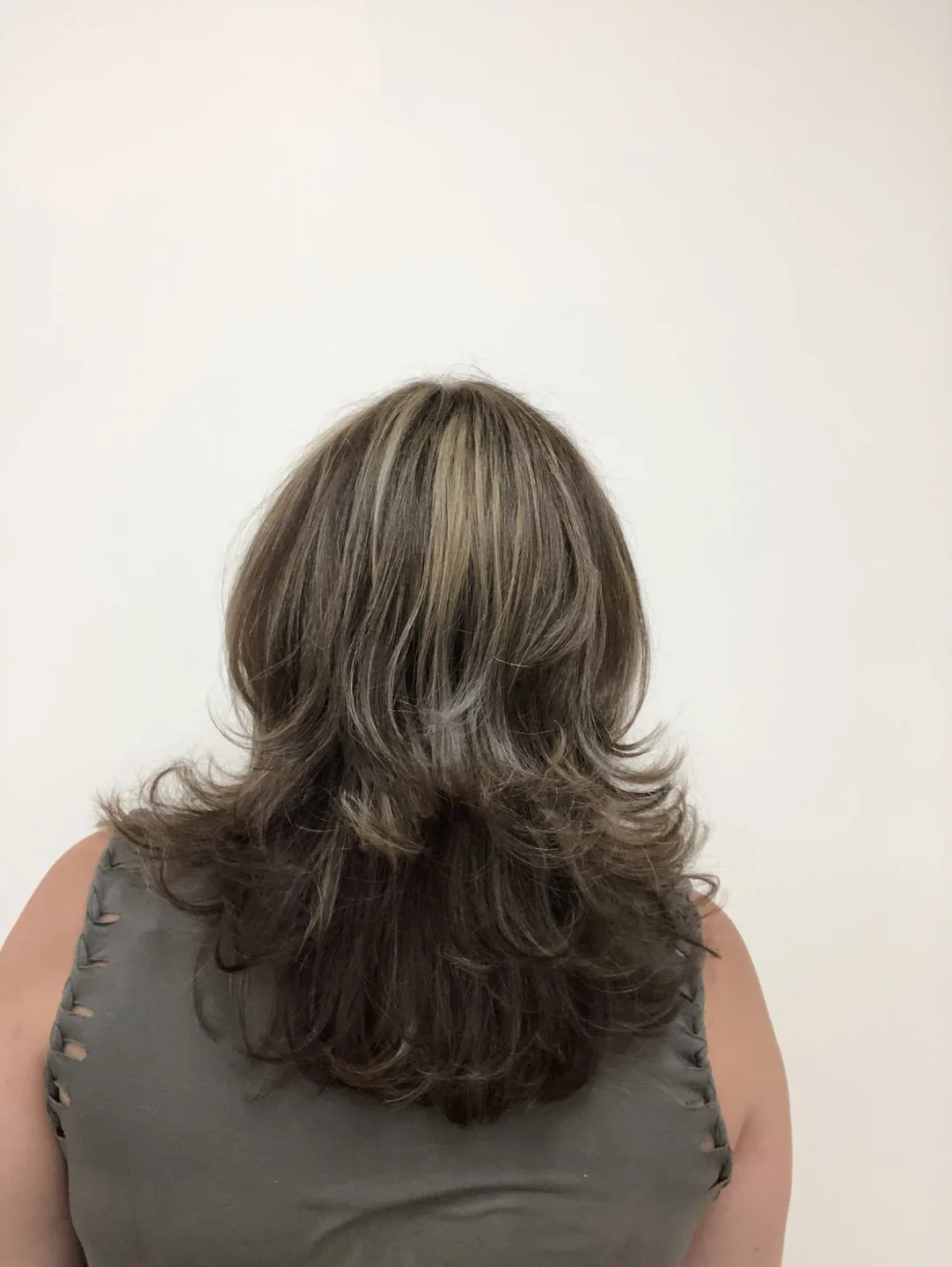 brunette layered cut with chunky highlights back-view