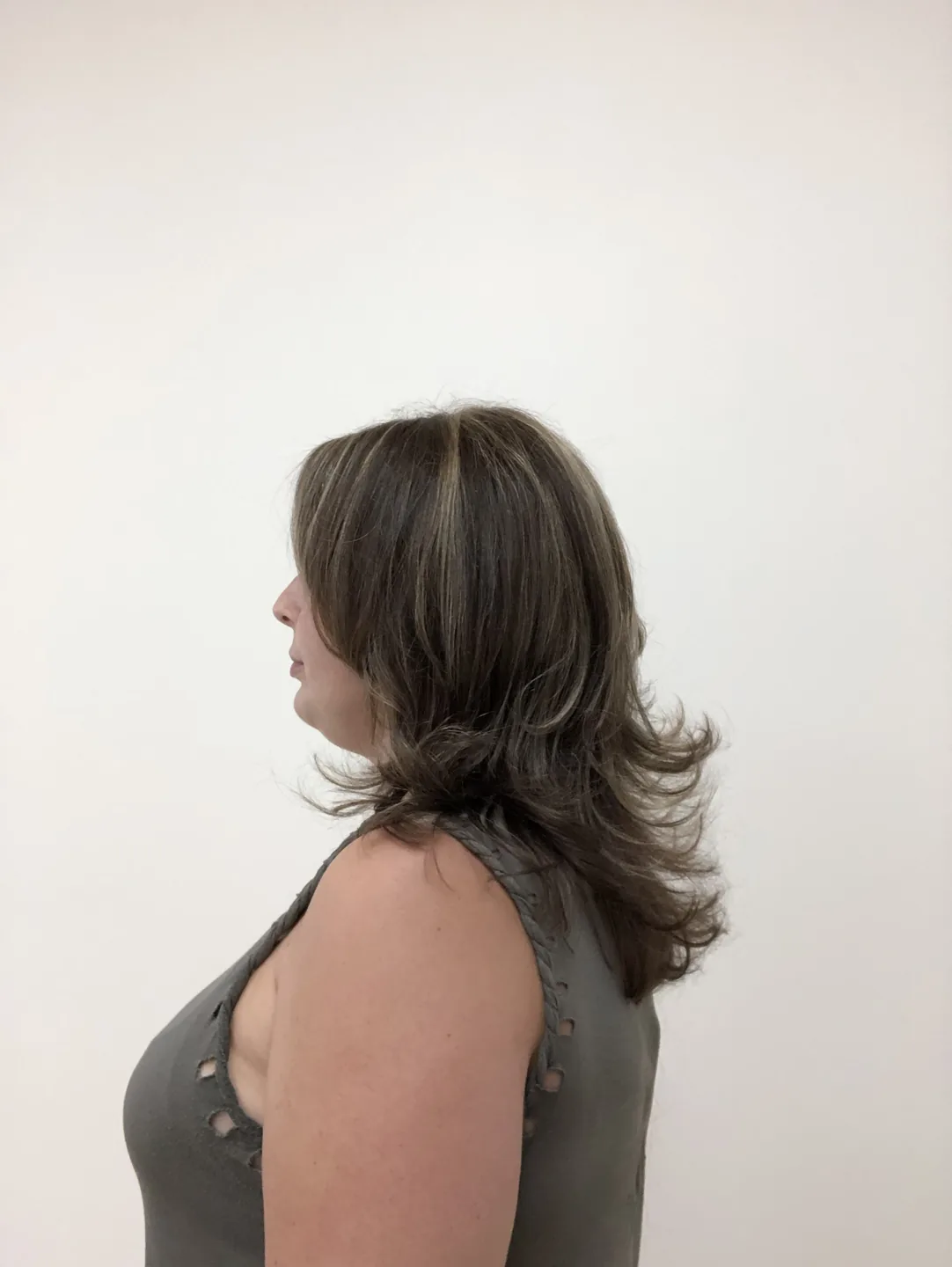 brunette layered cut with feathered ends side-profile